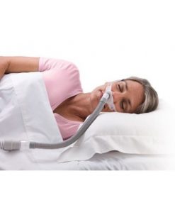 a woman sleeping with a ResMed Swift FX For Her Nasal Pillow Mask