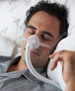 A man using the Philips Respironics Wisp Nasal Mask