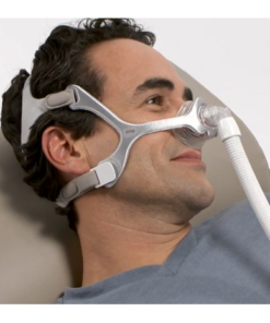 A man using the Philips Respironics Wisp Nasal Mask