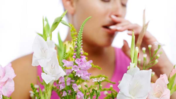 woman having allergies with floweres