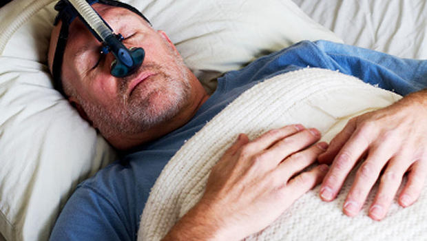 a man sleeping with cpap machine