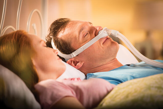 a man sleeping with cpap machine