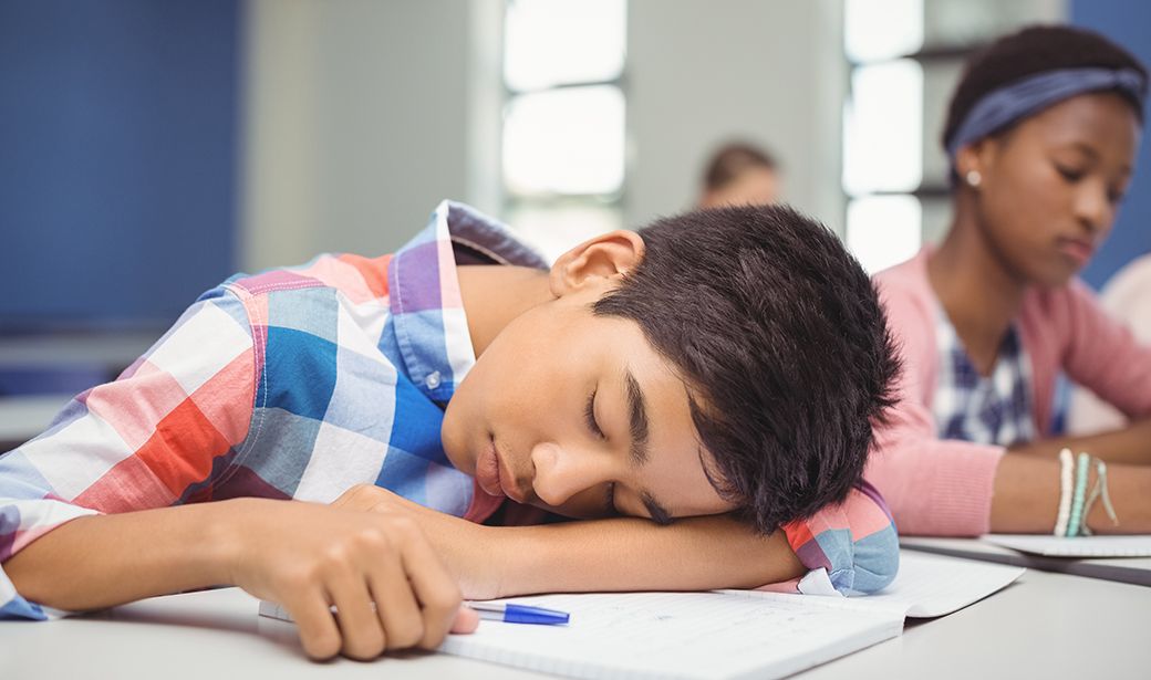 school teen getting asleep on the classroom