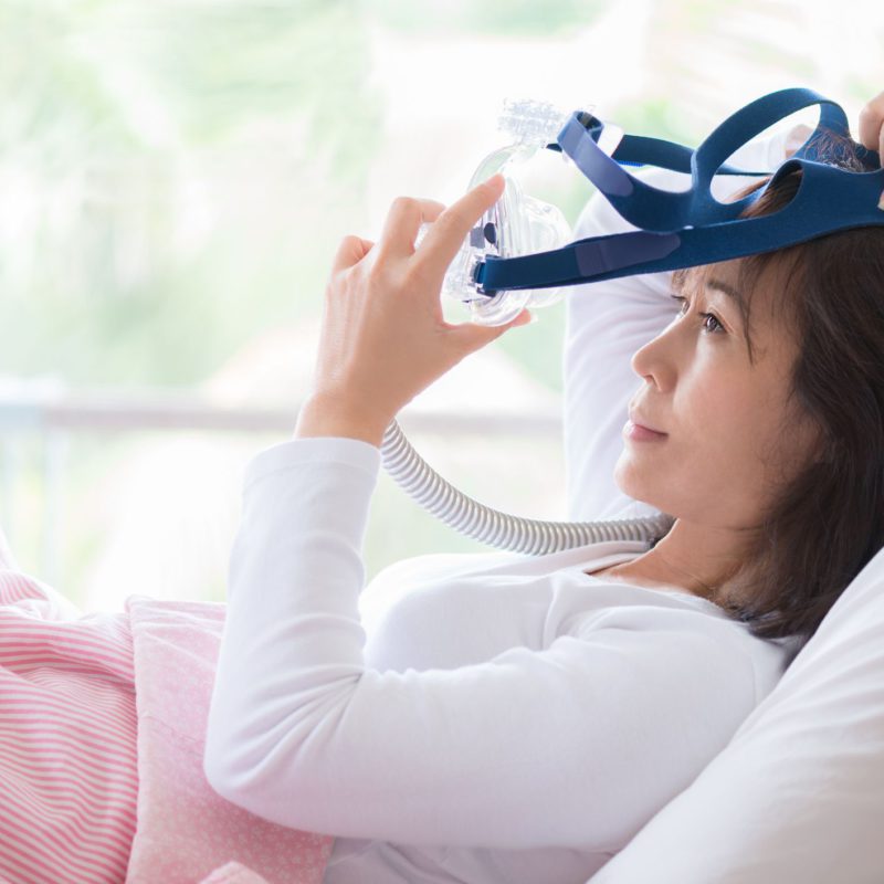 woman putting the cpap mask